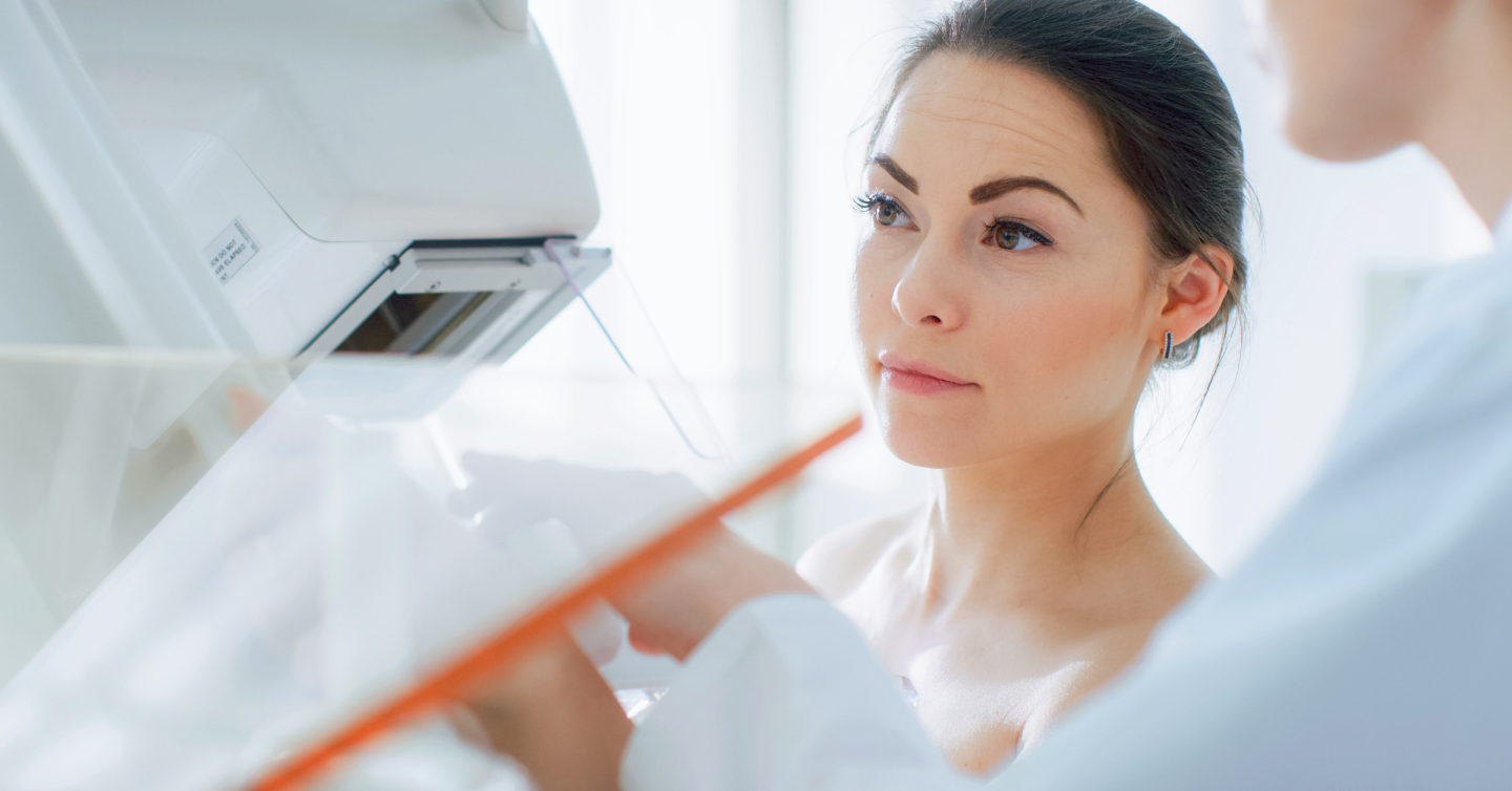 a young woman getting a mammogram for the first time