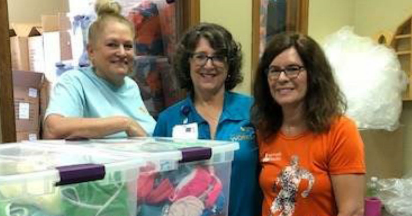 three people assisting with network health diaper drive