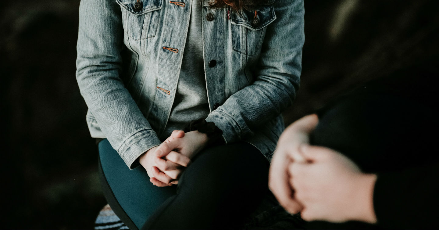 person sitting on couch seeing therapist