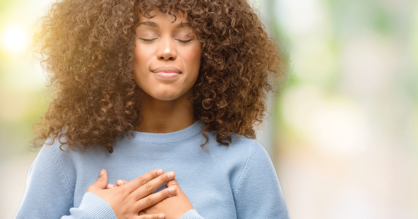 a women with her hands to her heart