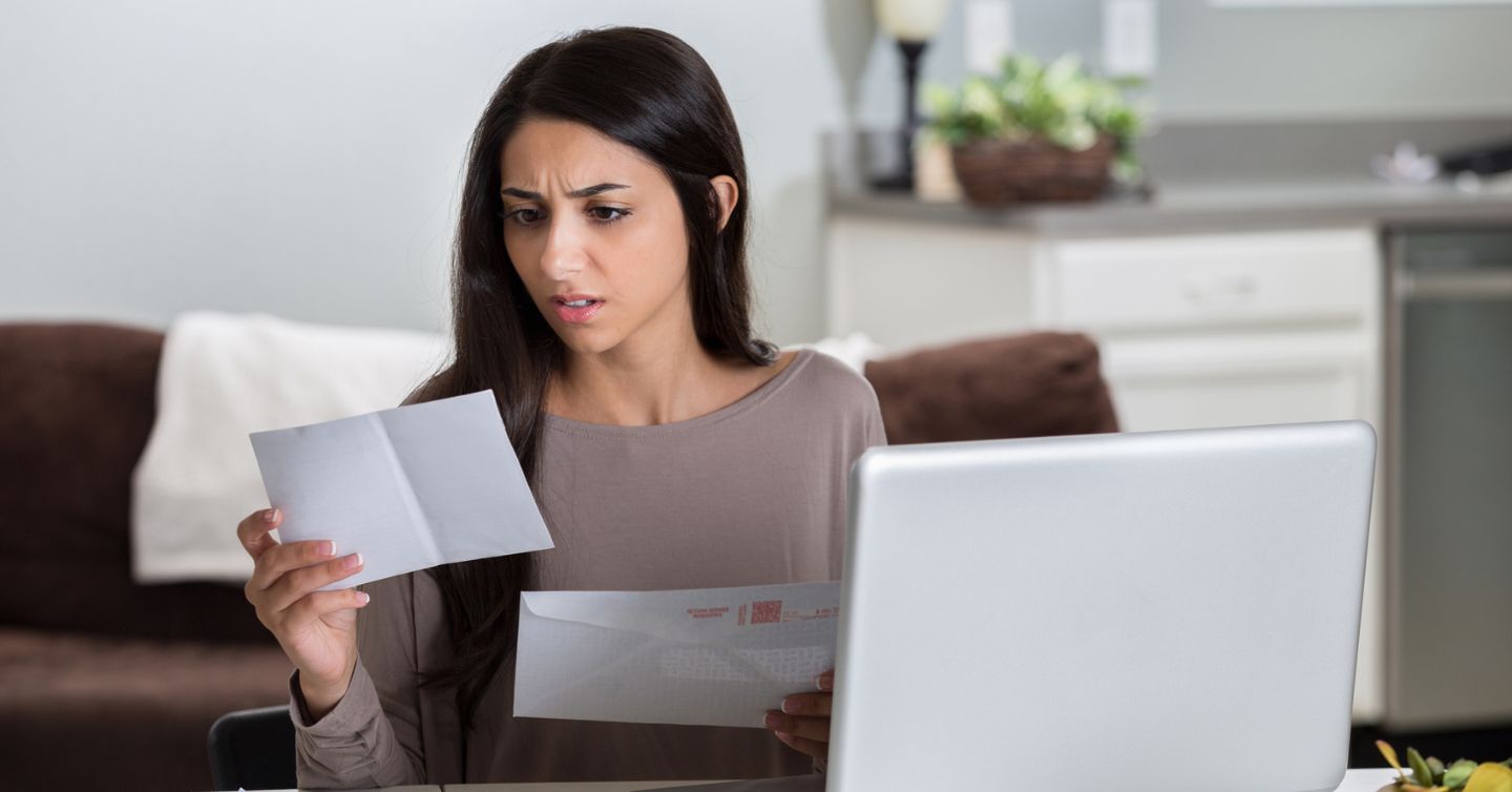 a woman looking at her medical bill that she didn't expect