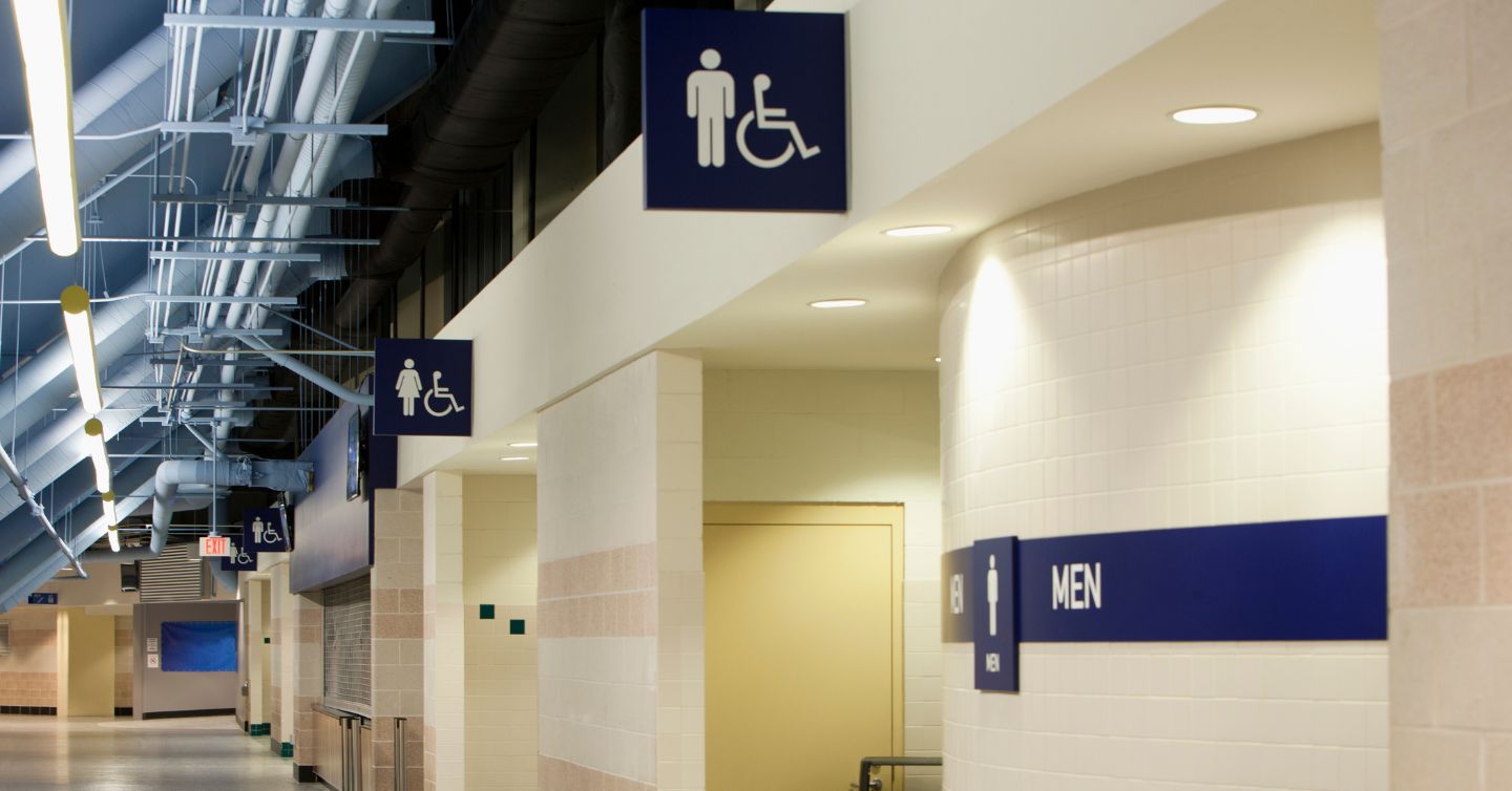 restroom signs in a concourse at a stadium
